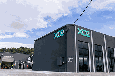 Front of XO2 head office building with the XO2 logo signs in view